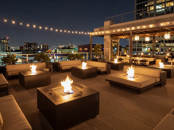 Rooftop restaurant terrace with fire pits and Orlando city views at night for premium sugar dating